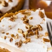 Slice of butterscotch pie on a white plate with recipe title on top of photo