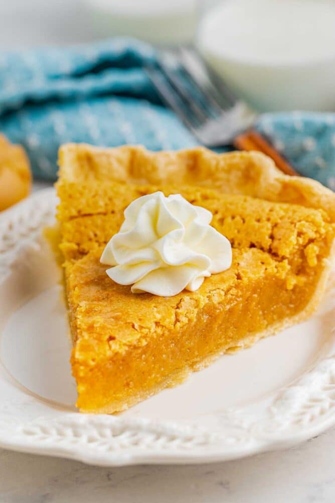 One slice of peanut butter chess pie with whipped cream on top