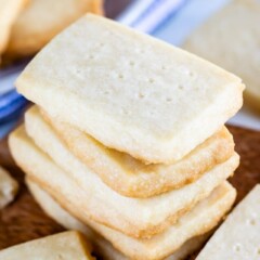 Stack of rectangular shortbread cookies on a wood cutting board