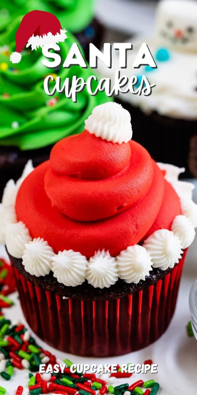 christmas cupcake decorated like a Santa hat with red frosting and white puffs