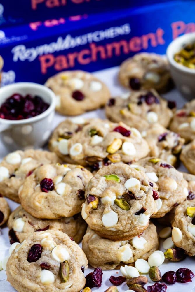 stack of cookies on white background with parchment paper behind