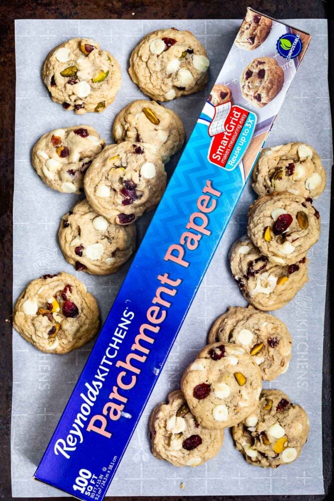 overhead shot of parchment paper on cookie sheet surrounded by cookies