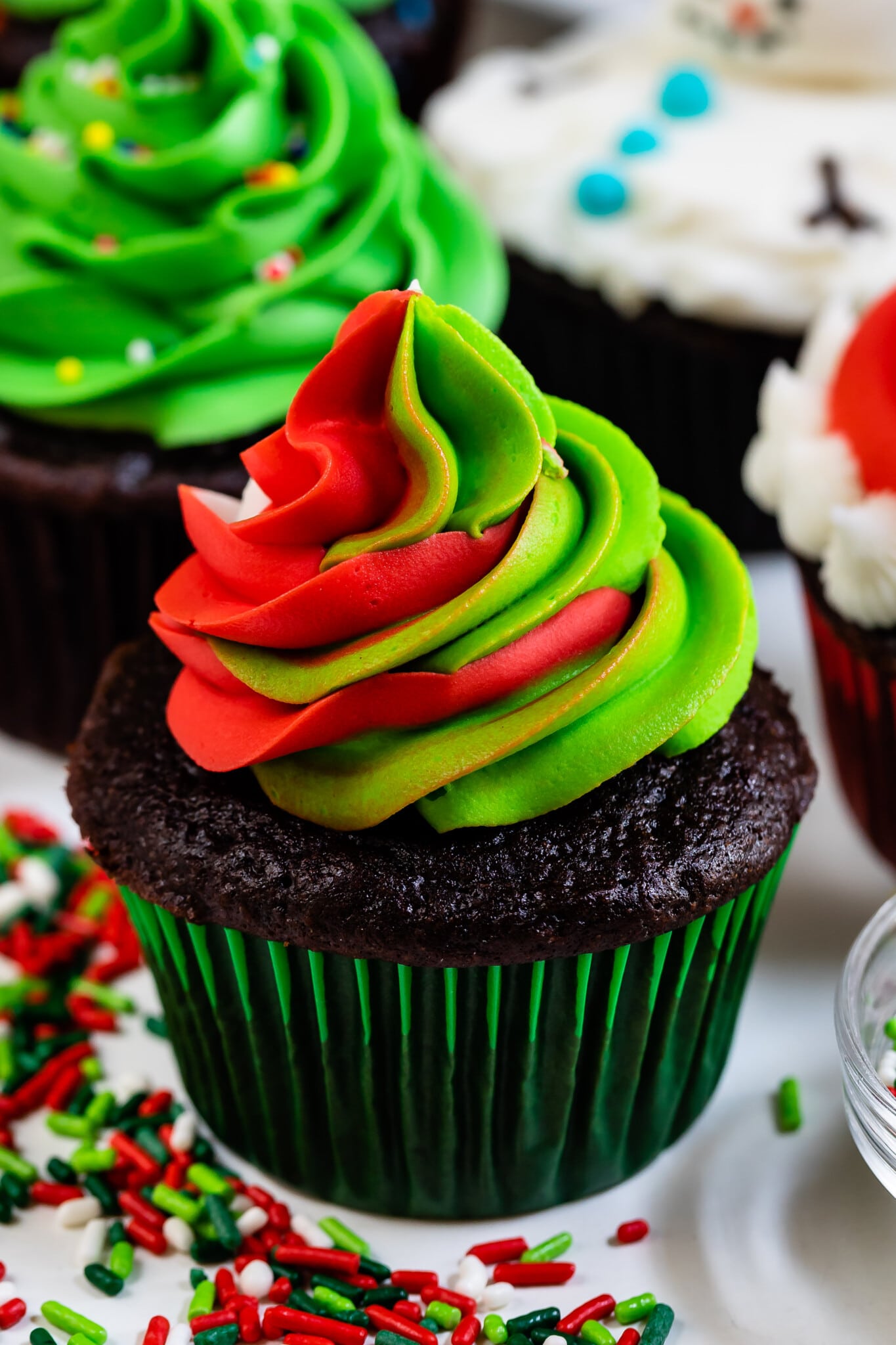 christmas cupcake in green liner with green and red swirled frosting