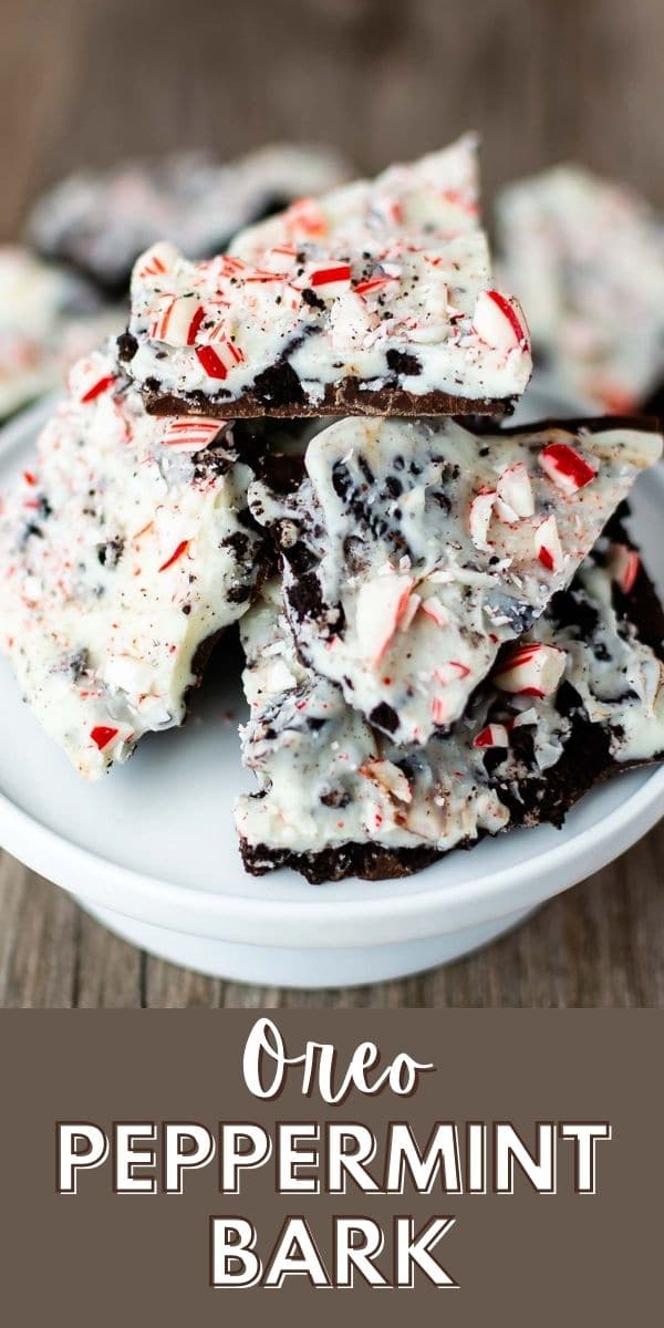 Oreo peppermint bark pieces on a white cake stand with recipe title on bottom of image