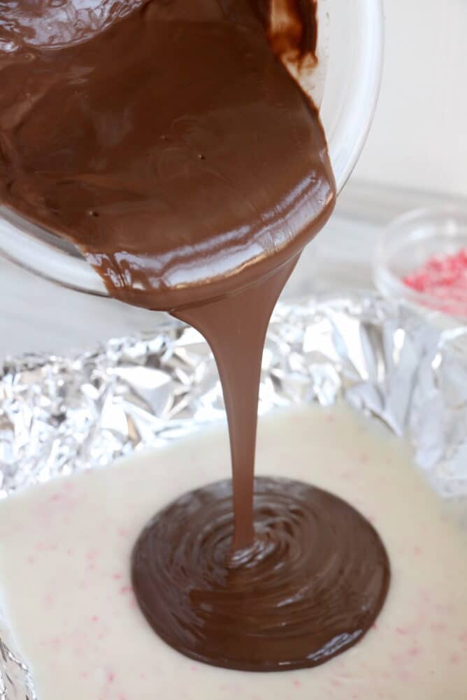 Process photo showing second chocolate layer being poured over first layer