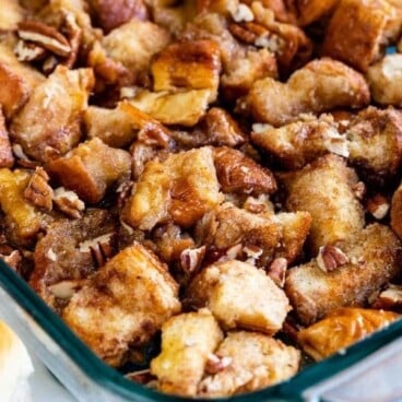 Monkey Bread in a glass baking dish with pecans on top and recipe title on bottom of image