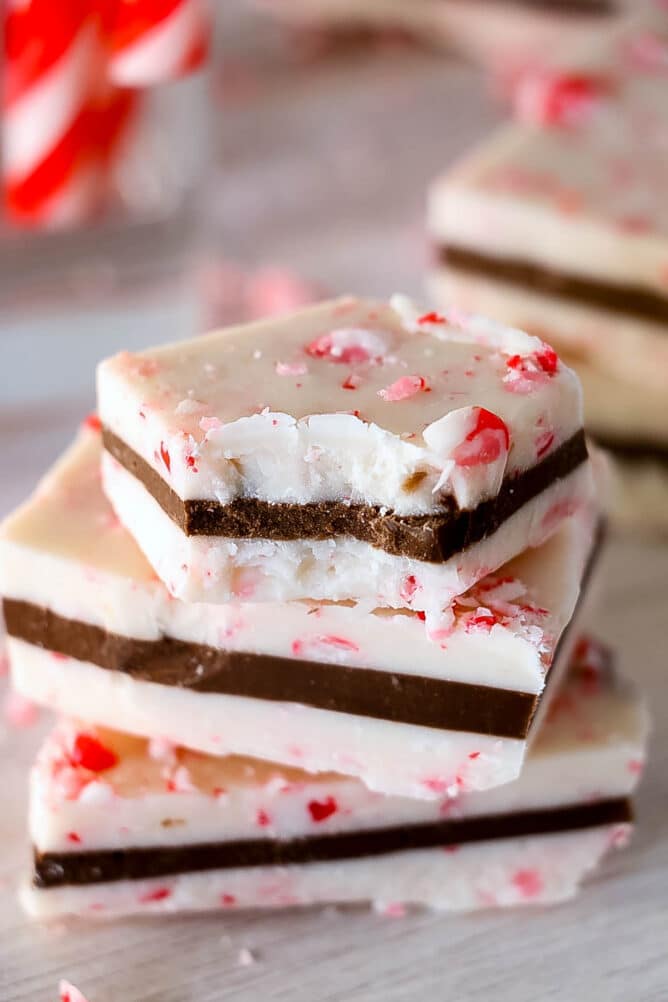 Peppermint bark pieces stacked on top of eachother with top piece missing one bite