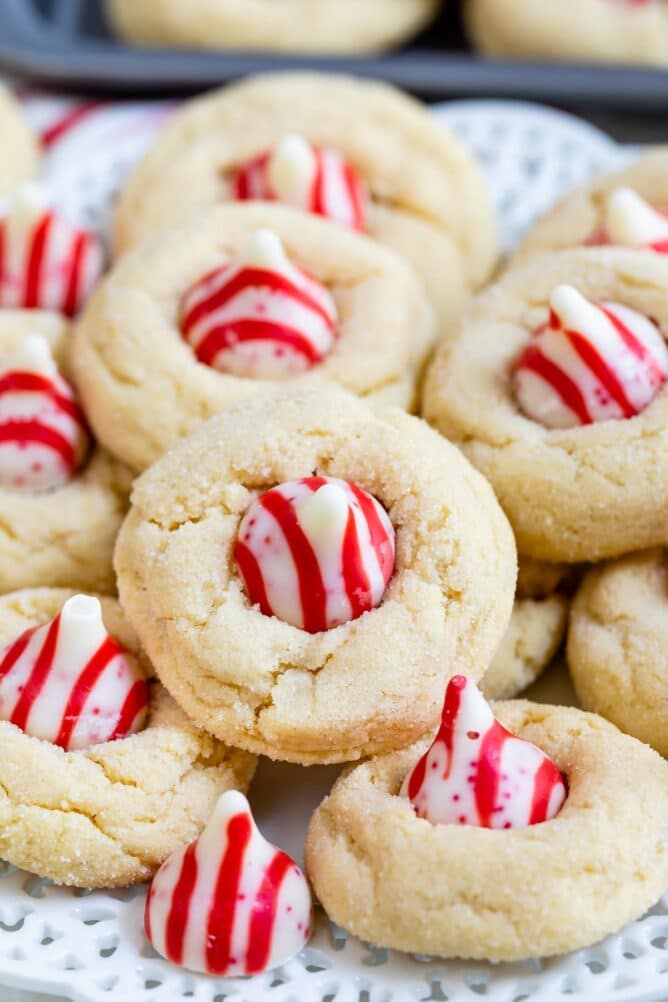 Bunch of peppermint blossom cookies on a white scalloped plate