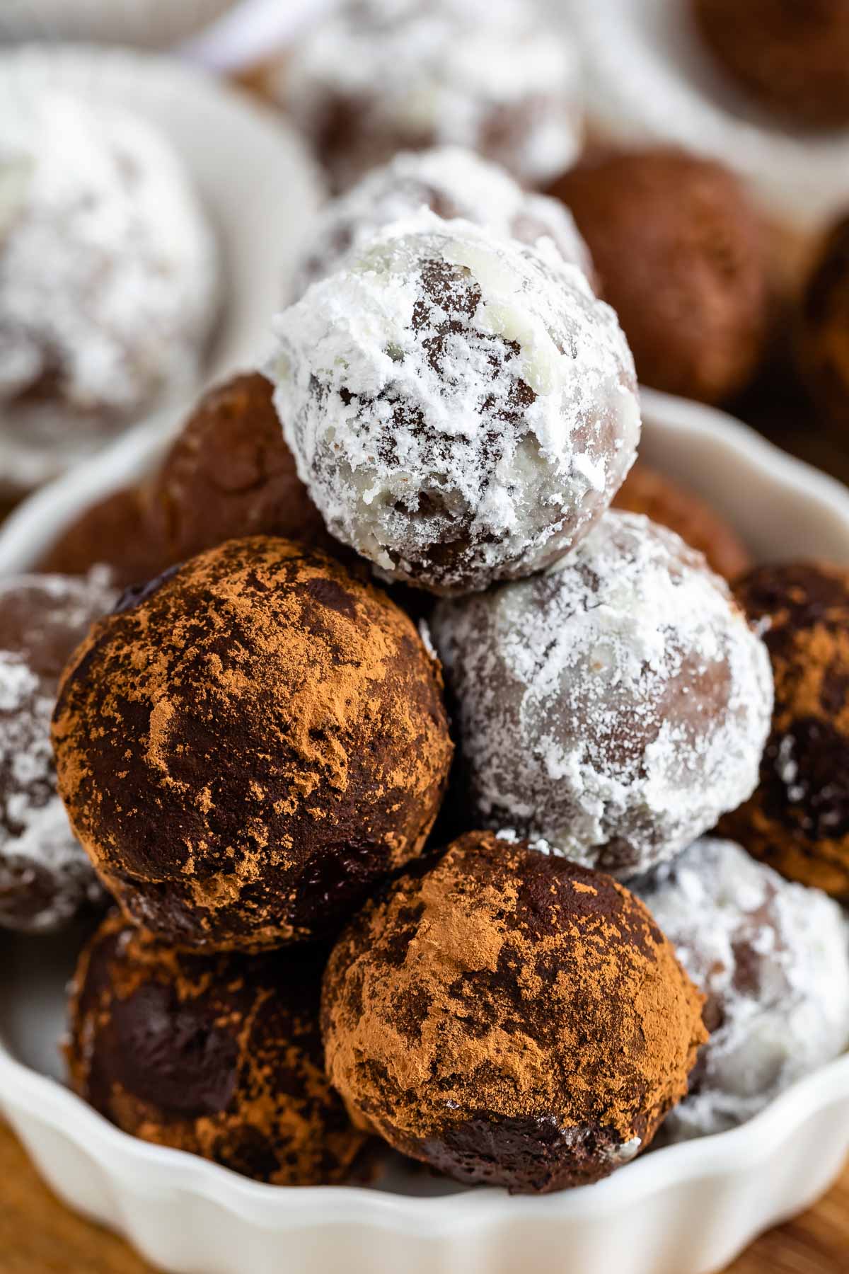 Rum balls stacked in a white dish