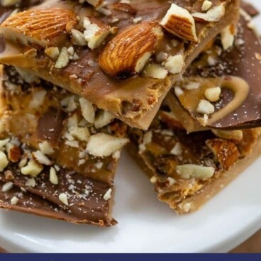 Toffee pieces stacked on a white serving plate with recipe title on bottom of image