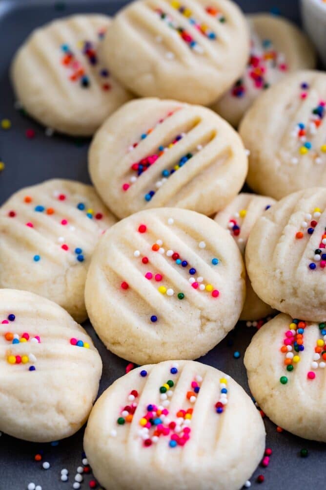 whipped shortbread cookie recipe in a pile with rainbow nonpareils
