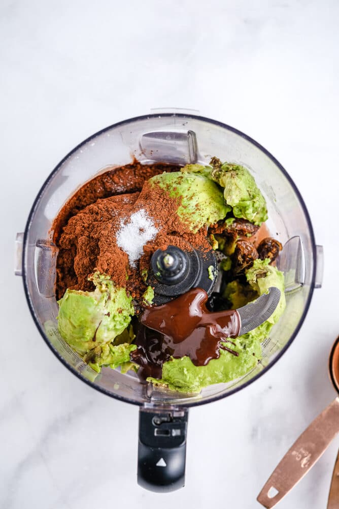 Overhead view of all ingredients inside a food processor before being mixed