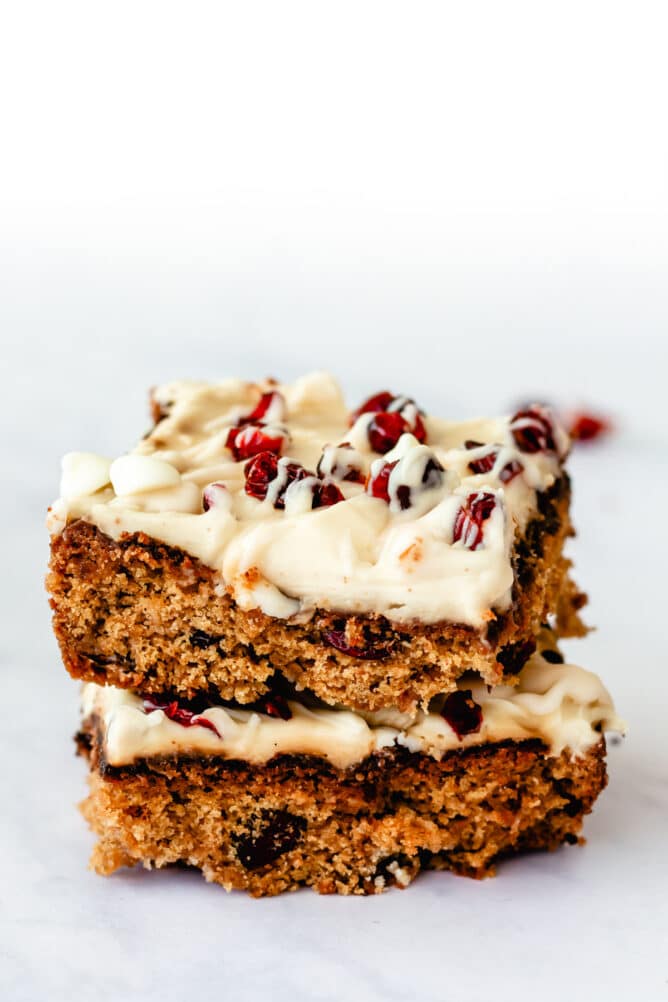 Two cranberry bliss bars stacked on eachother