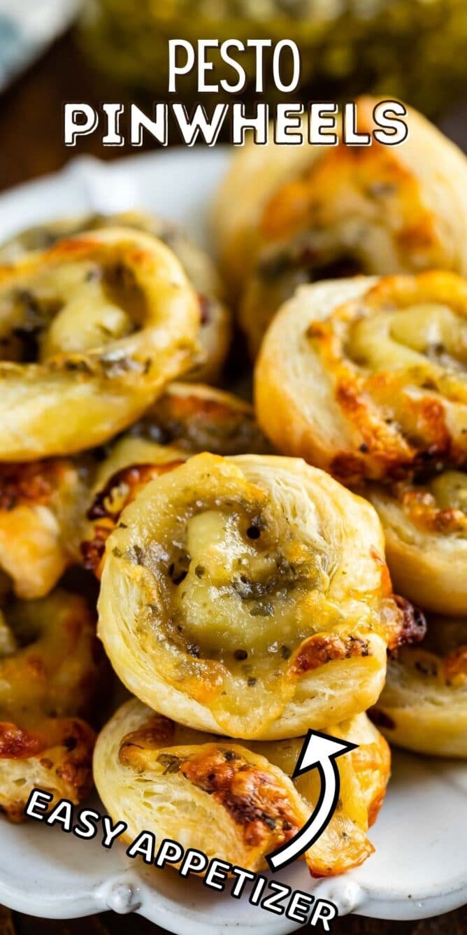 Pesto pinwheels on a white plate with recipe title on the top of image