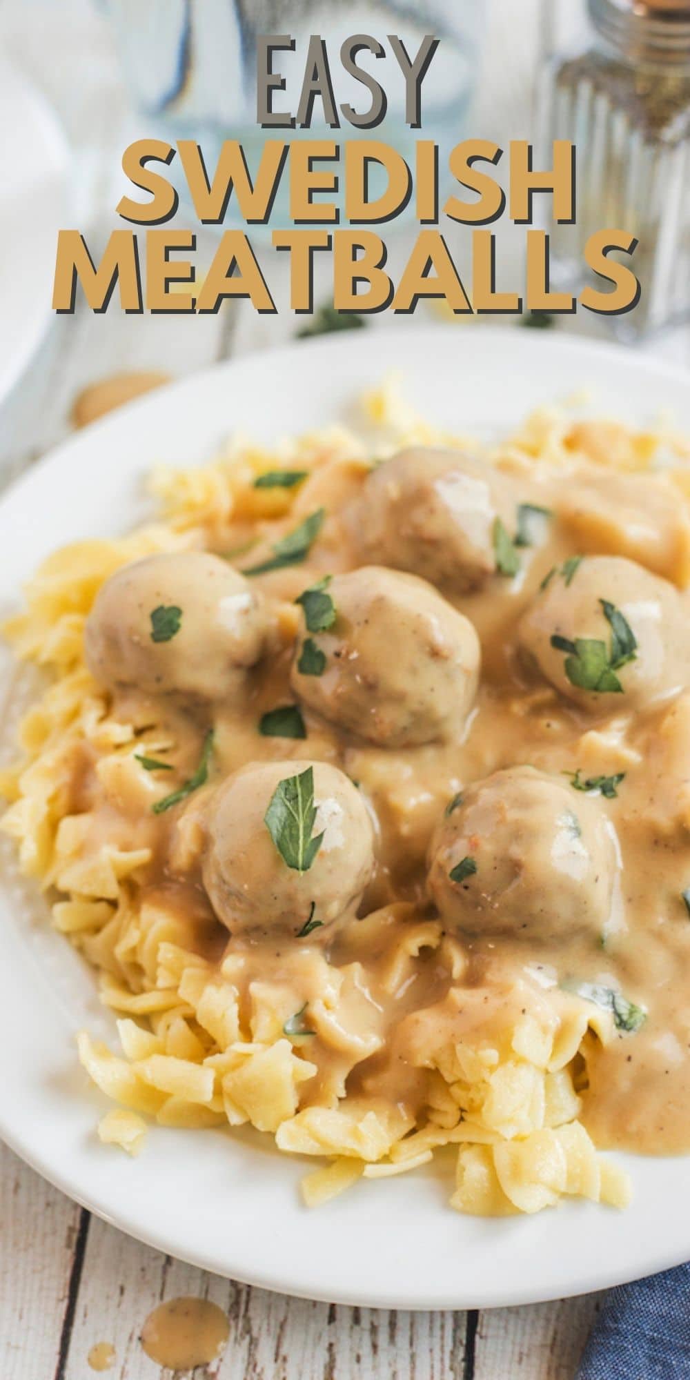 Plate full of swedish meatballs over egg noodles with recipe title on top of image