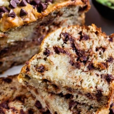 Avocado banana bread loaf cut into slices with recipe title on top of image
