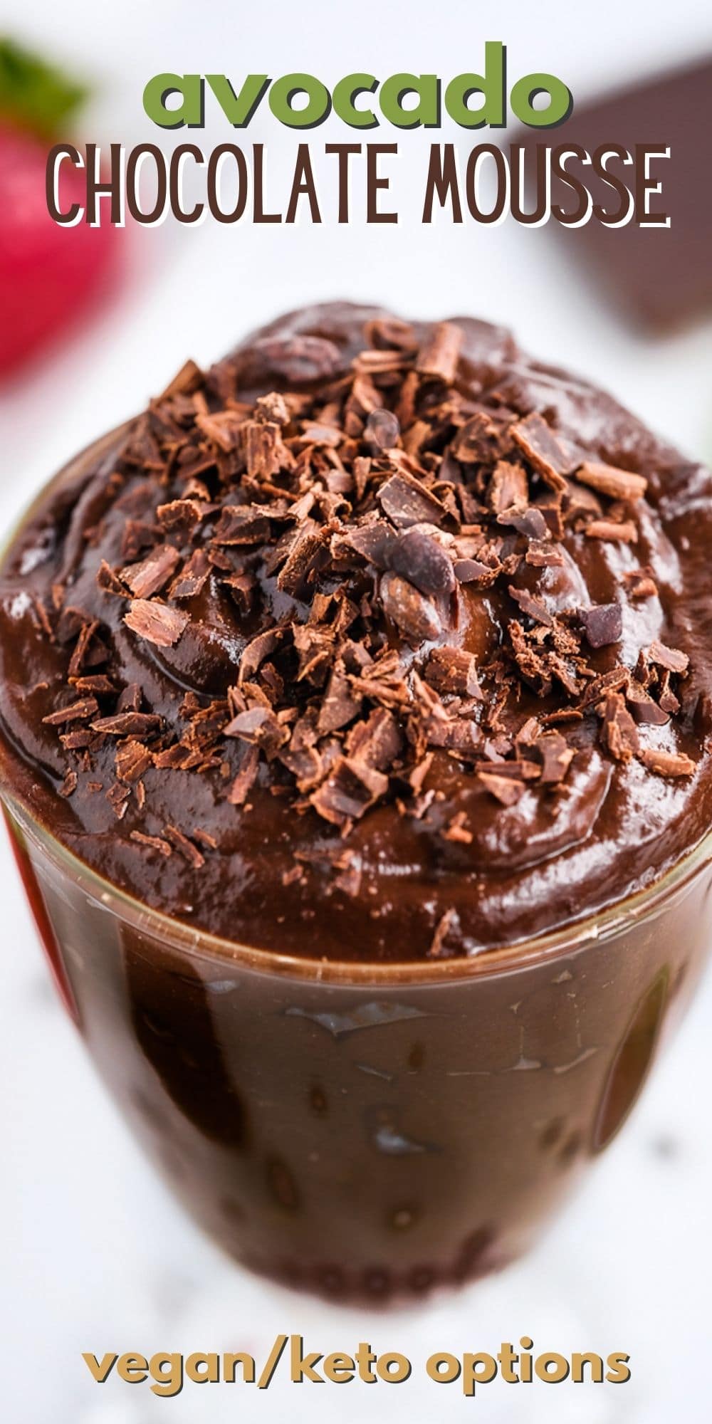 Overhead shot of avocado chocolate mousse with chocolate shavings on top and recipe title on top of image