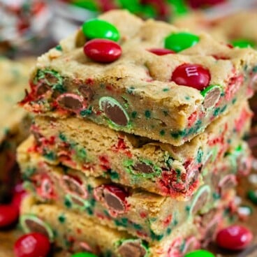 Stack of christmas cookie bars with m&ms around them