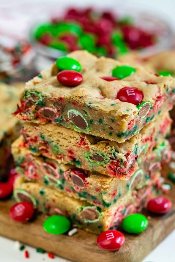 Stack of christmas cookie bars with m&ms around them