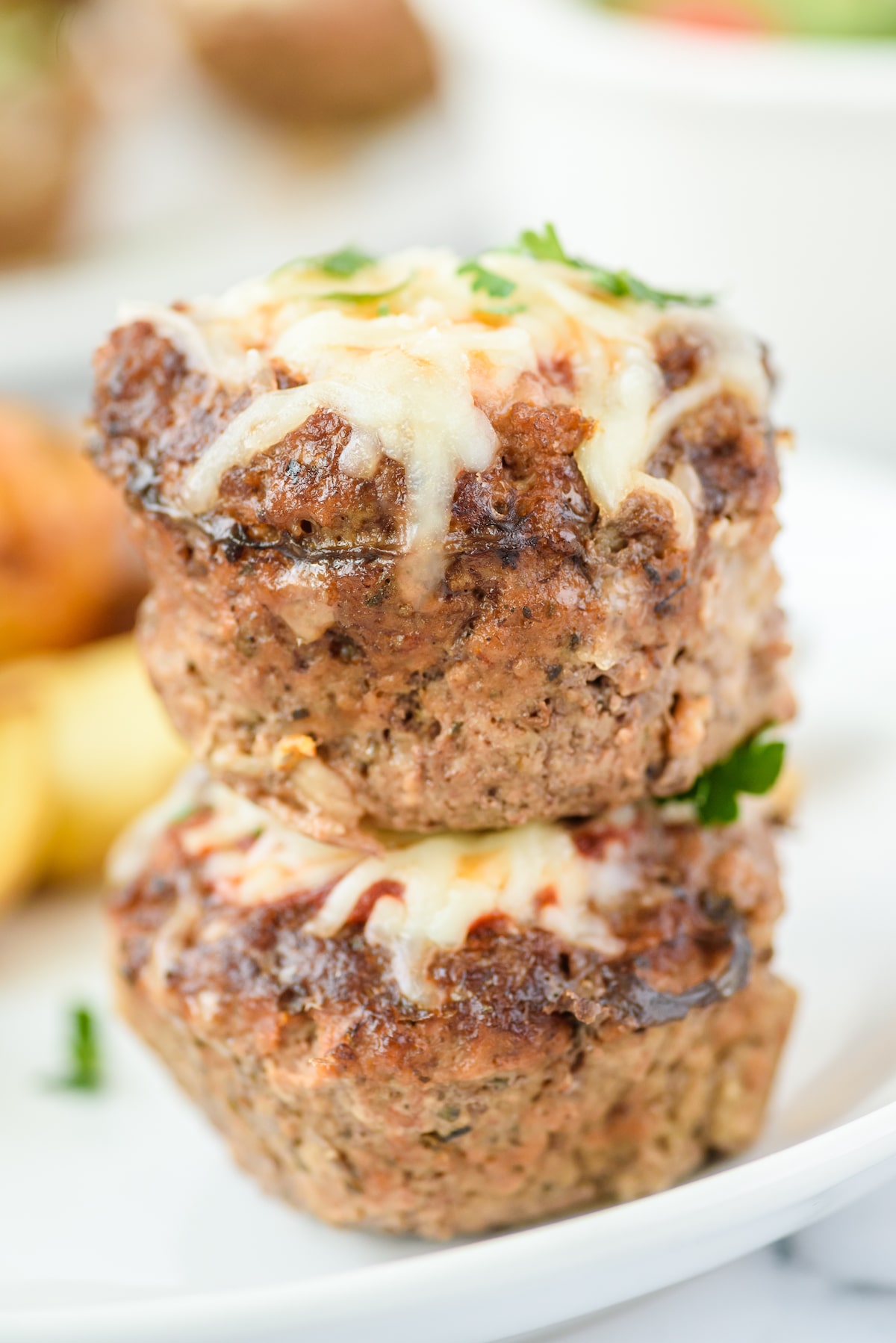 Close up shot of two mini meatloaves stacked on eachother