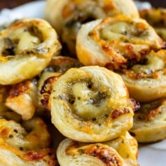 Close up shot of pesto pinwheels on a white plate