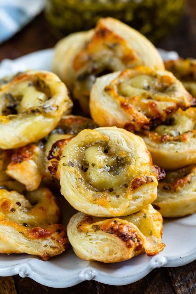 Close up shot of pesto pinwheels on a white plate