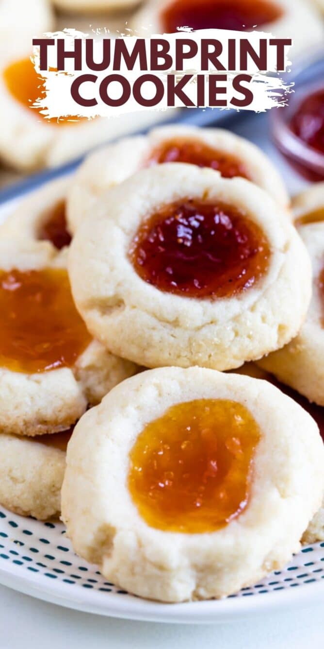 Overhead view of a plate full of jam thumbprint cookies with recipe title on top of image