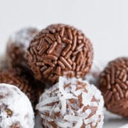 Close up shot of chocolate avocado truffles with sprinkles and coconuts on the outside