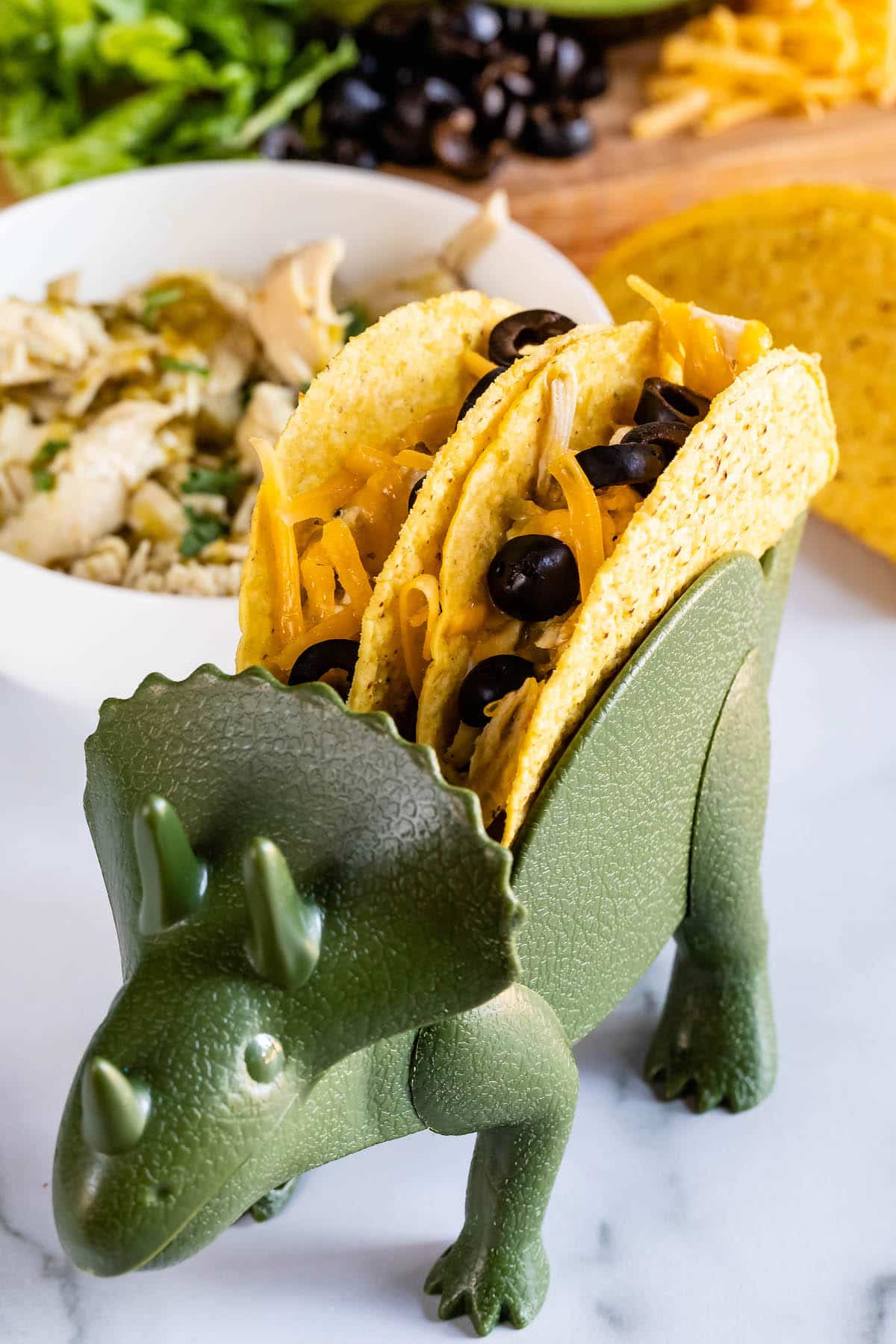 taco in tacosaurus holder.