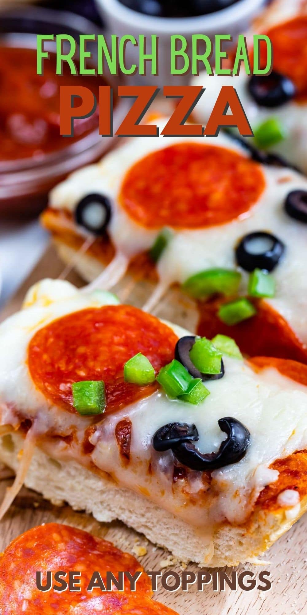 slices of French bread pizza with pepperoni and olives on cutting board