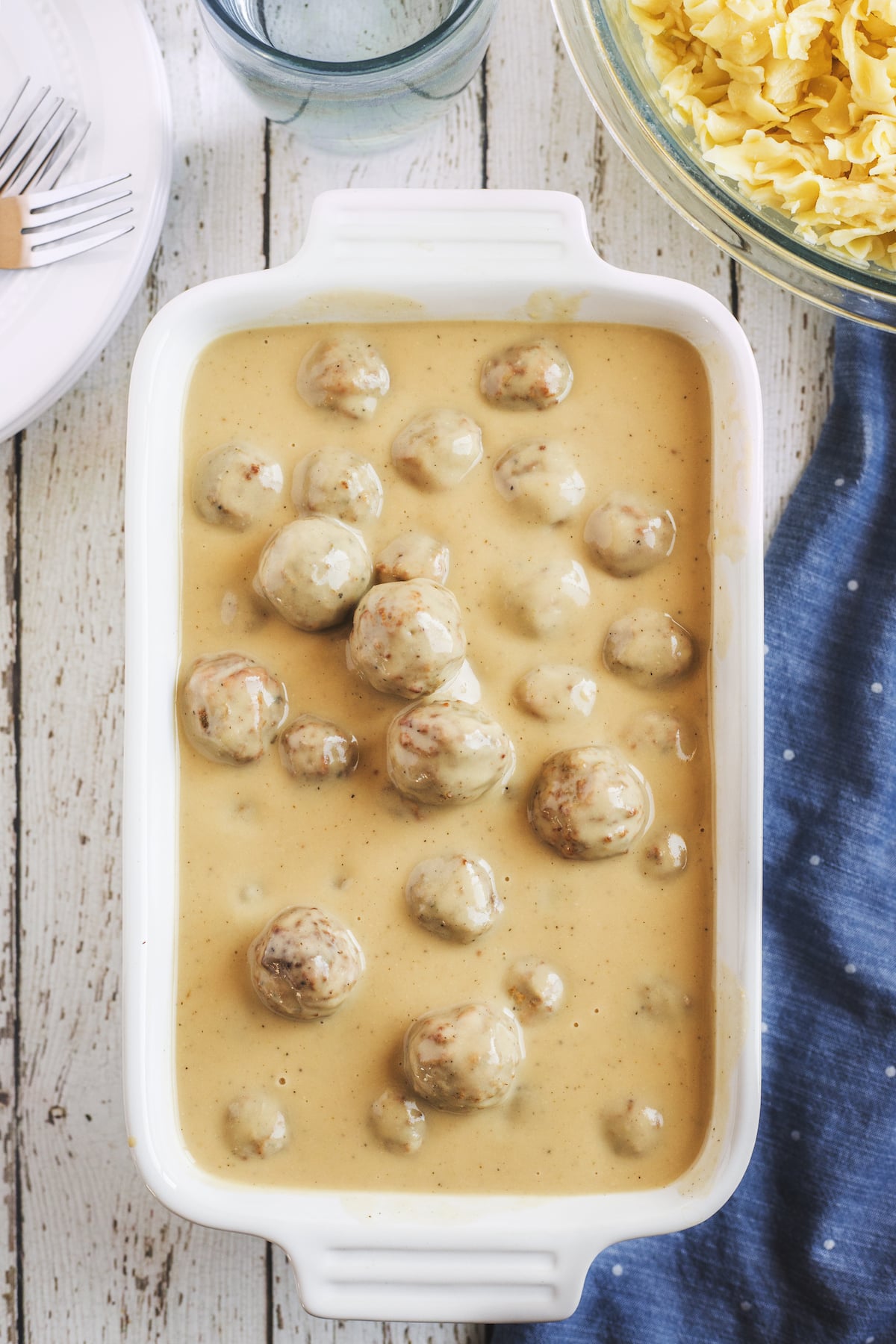 meatballs in casserole dish with sauce.