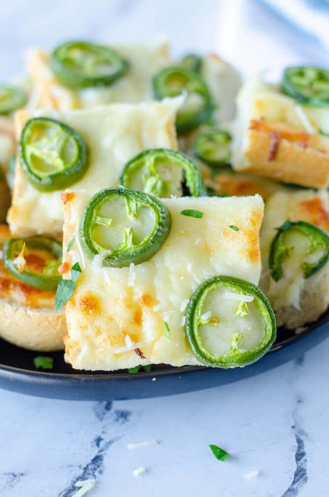 Plate full of jalapeno cheese bread slices