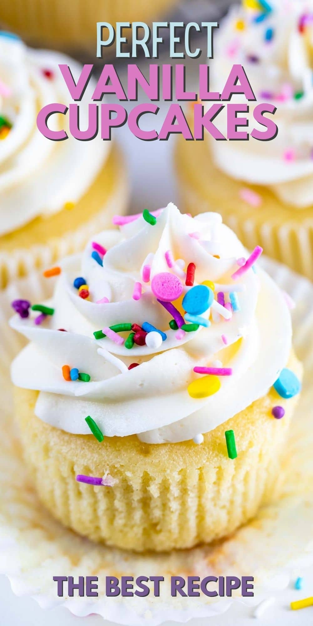 Close up of perfect vanilla cupcake with vanilla buttercream and topped with rainbow sprinkles and recipe title on top of image