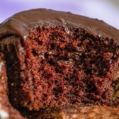 The best chocolate cupcake cut in half to show the fluffy inside with recipe title on top of image