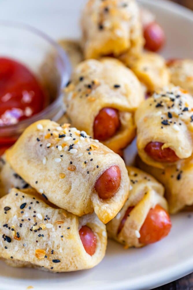 Everything pigs in a blanket on a plate with dipping sauce