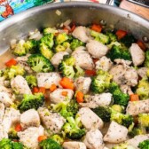 garlic butter chicken in skillet with vegetables and words on photo