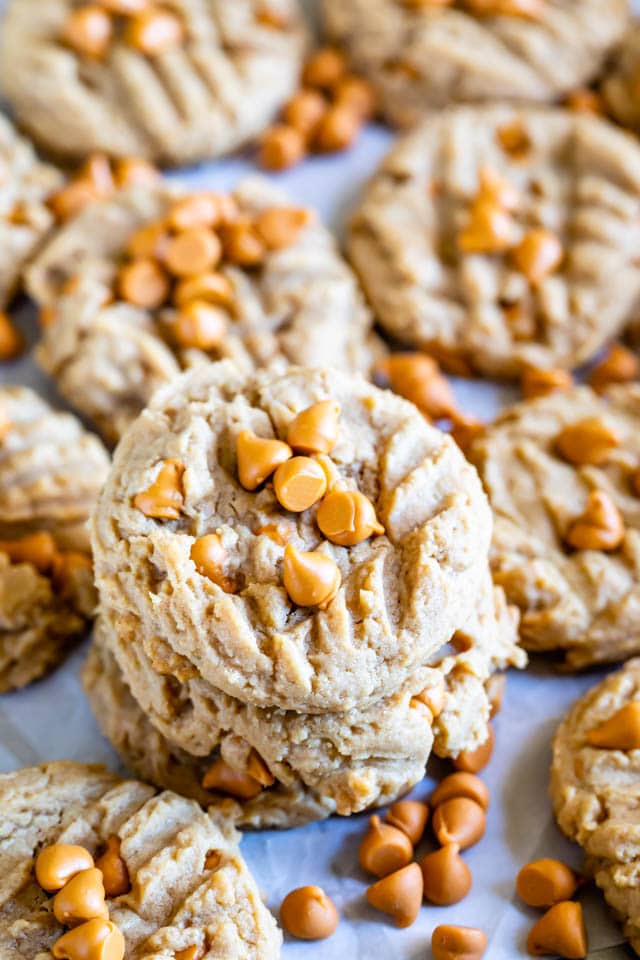 Peanut butter butterscotch cookies stacked on eachother with more surrounding them