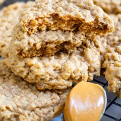 Peanut butter oatmeal cookies stacked on eachother with top cookie cut in half to show inside