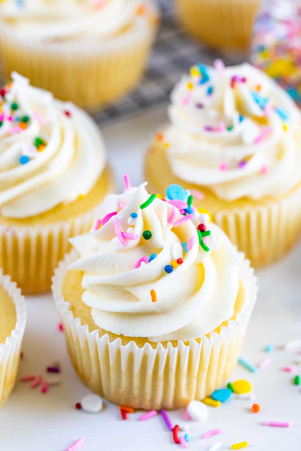 Perfect vanilla cupcakes with vanilla buttercream and rainbow sprinkles on top