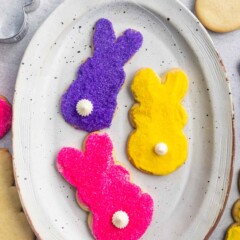 Overhead shot of three decorated bunny cookies on a white serving plate