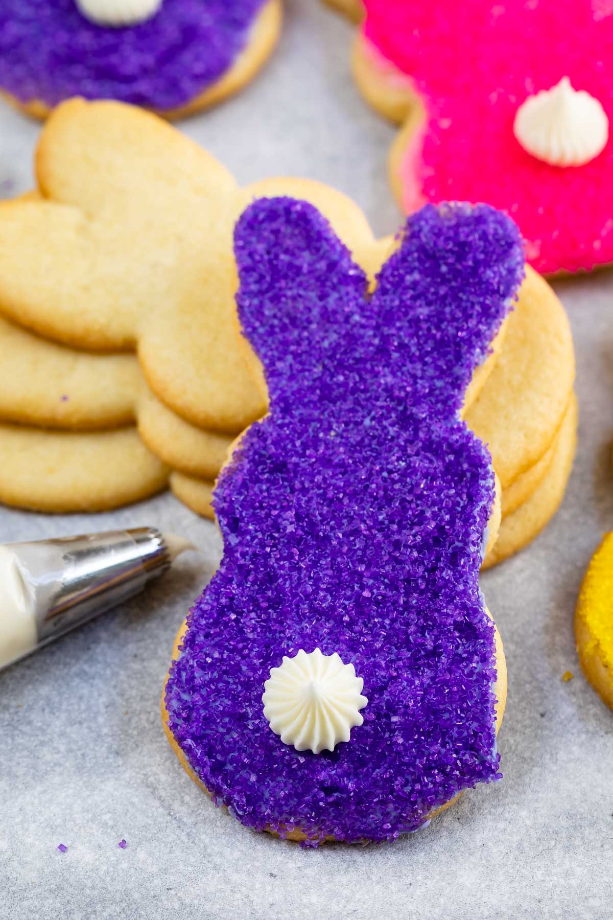 Close up shot of purple bunny butt cookie with white icing tail
