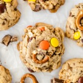 Overhead close up photo of toffee pretzel peanut butter cookies on parchment paper