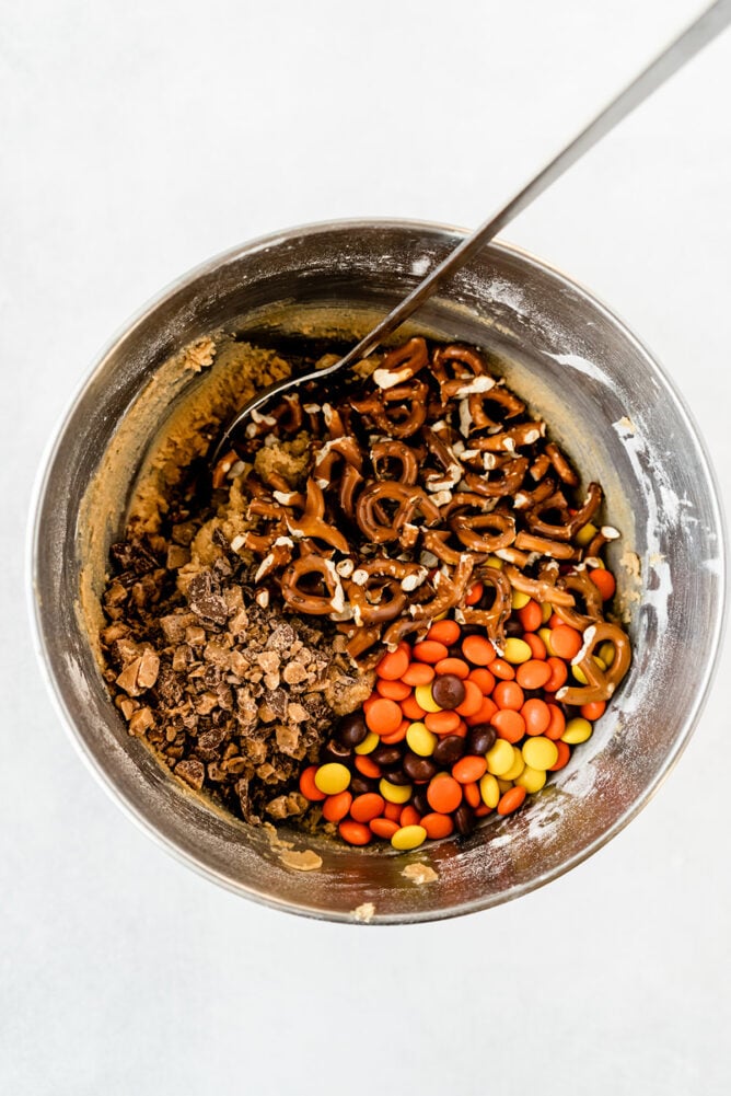 Overhead shot of all the ingredients being mixed together to make toffee pretzel peanut butter cookies