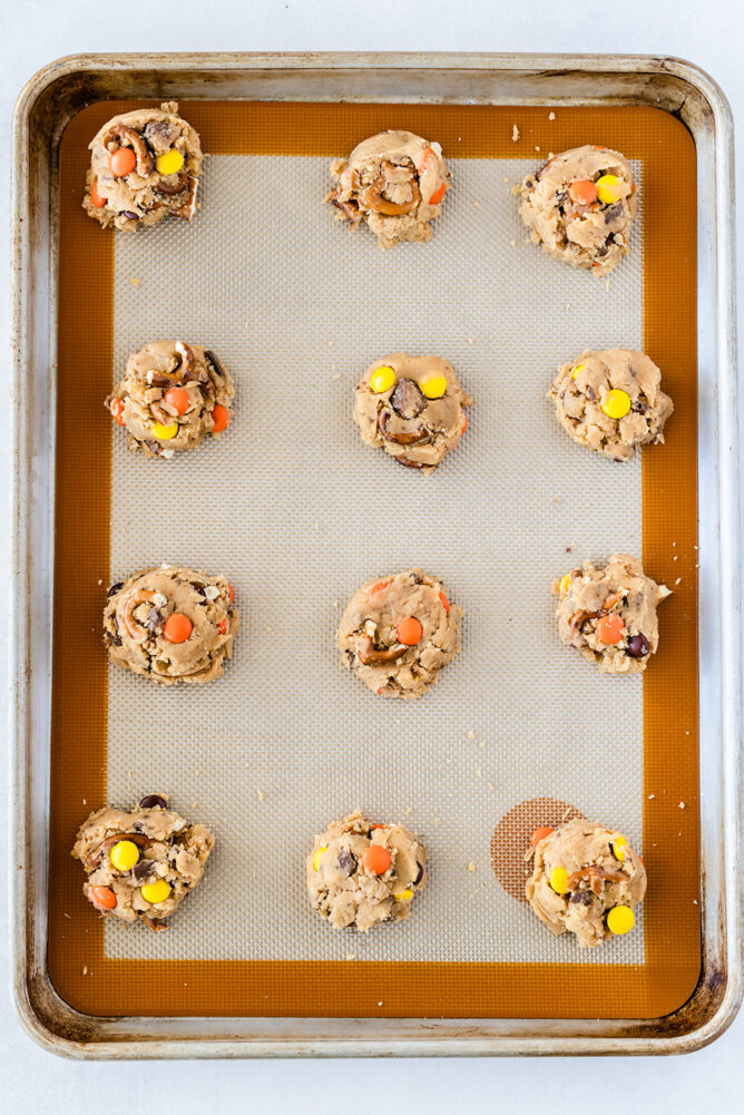 Toffee pretzel peanut butter cookie dough balls on baking sheet