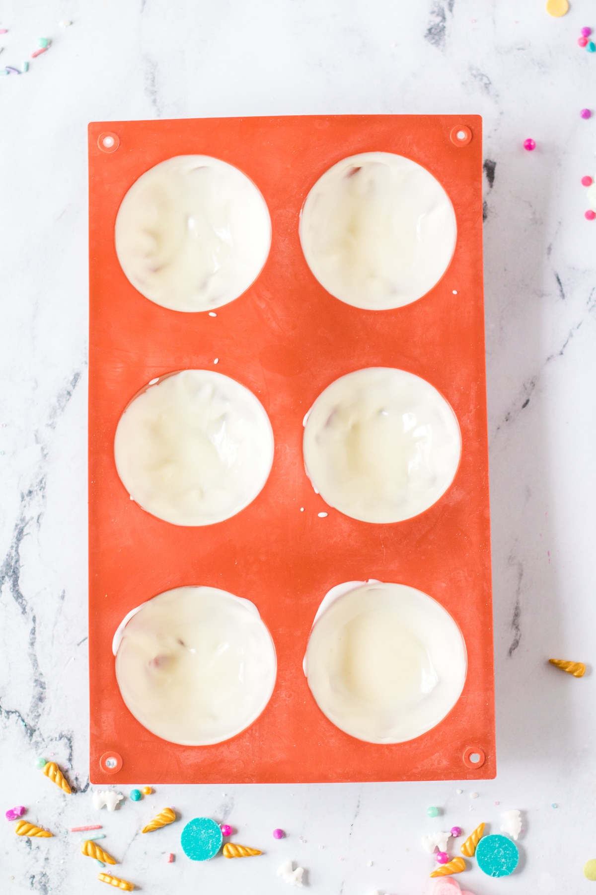 Overhead shot of white chocolate in circle molds