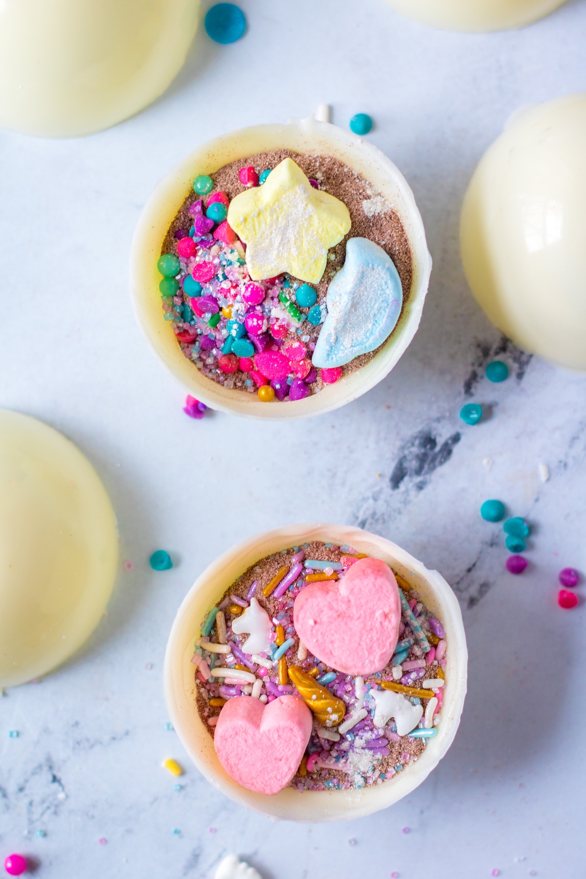 Overhead shot showing the inside of two white hot chocolate bombs