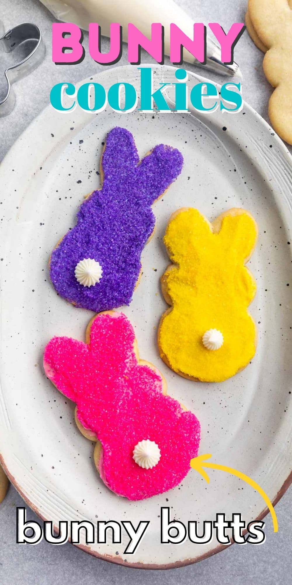 Overhead shot of three decorated bunny cookies on a white serving plate with recipe title on top of image