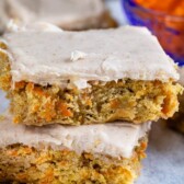 Stack of two carrot cake blondies on parchment paper