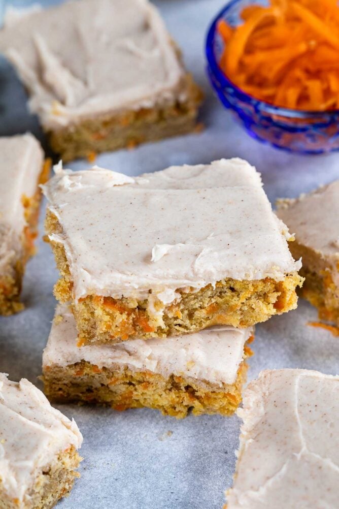 Overhead shot of carrot cake blondie squares on parchment paper