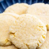 Plate full of cornmeal cookies with recipe title on top of image
